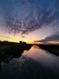 Scenic view of lake against romantic sky at sunset