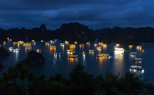 Illuminated city against sky at night