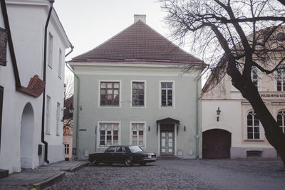 Cars on road amidst buildings in city