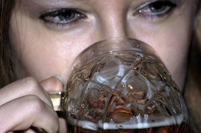 Close-up portrait of a woman drinking glass