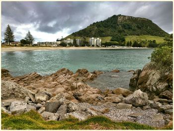 Scenic view of lake against cloudy sky