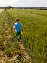 Rear view of boy on field