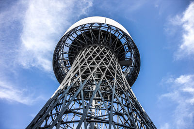 Low angle view of communications tower against sky