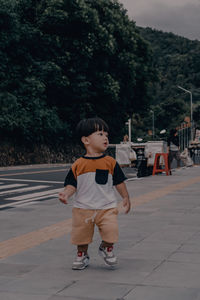 Portrait of boy walking on road