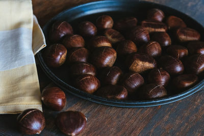 High angle view of roasted coffee beans in bowl on table