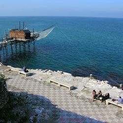 High angle view of people by sea against sky