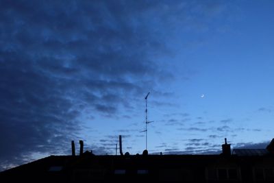 Low angle view of silhouette building against sky at dusk