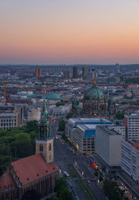 High angle view of buildings in city at sunset