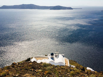 High angle view of people sitting on sea shore