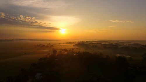 Scenic view of landscape against sky during sunset