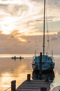 Boats on sea against sky during sunset