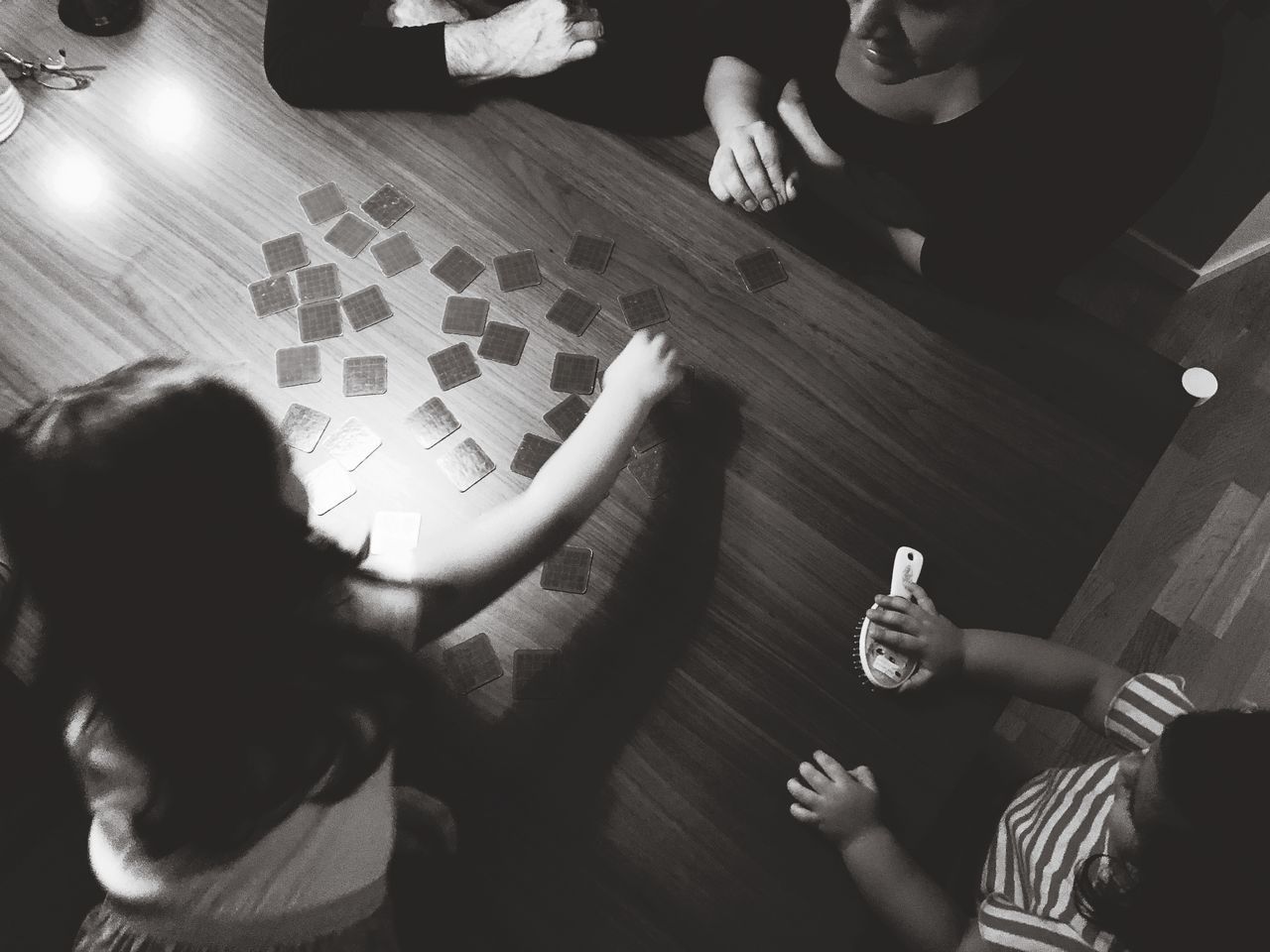 HIGH ANGLE VIEW OF CHILDREN PLAYING WITH BABY