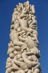 Low angle view of monolith  against clear blue sky