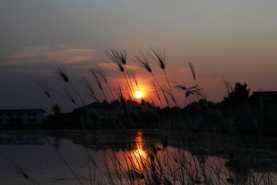 Scenic view of lake against romantic sky at sunset