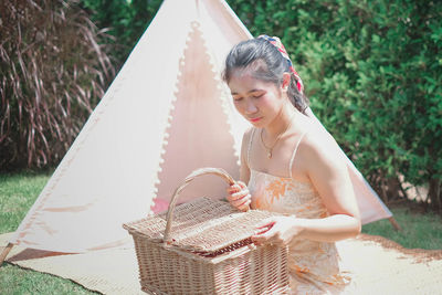 Beautiful young woman holding basket