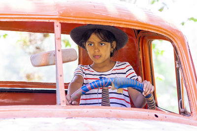 Portrait of boy sitting outdoors