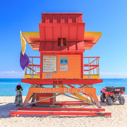 Lifeguard hut on beach against sky