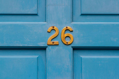House number 26 on a blue wooden front door in london 