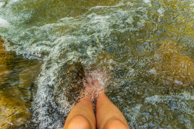 Low section of woman legs in sea