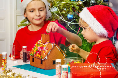 Portrait of smiling woman holding christmas decorations