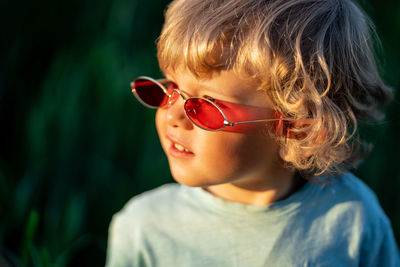 Close-up portrait of cute boy wearing sunglasses