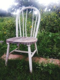Empty chair and table on field