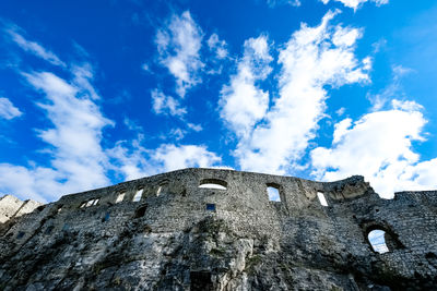 Low angle view of fort against cloudy sky