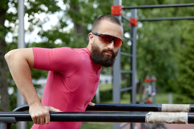 Portrait of young man exercising in gym