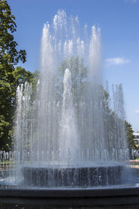 Water splashing in fountain against sky