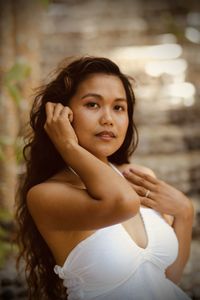 Portrait of beautiful young woman sitting outdoors