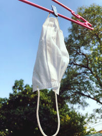 Low angle view of clothes hanging on clothesline against sky