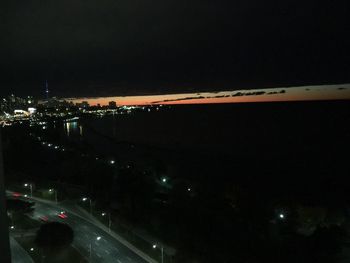 Aerial view of illuminated city at night