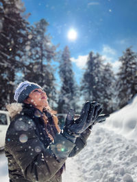 Rear view of woman standing in snow