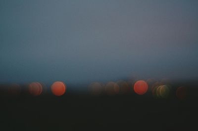 Defocused image of lights against sky at night