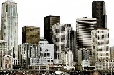 Modern buildings in city against clear sky