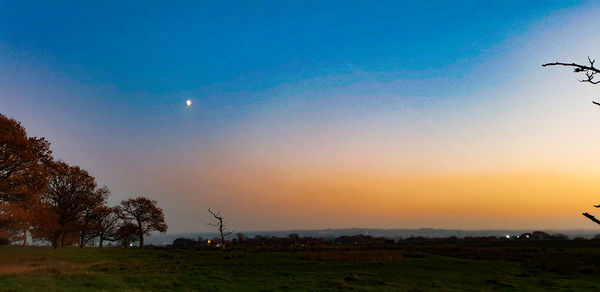 Scenic view of field against sky during sunset