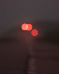 Defocused image of lights against sky at night