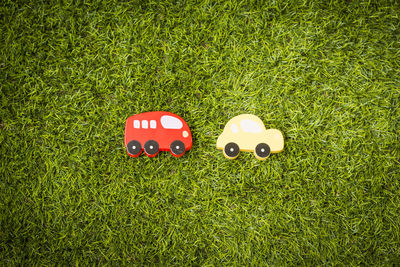 Directly above view of wooden cars on field