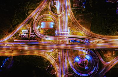 High angle view of light trails on bridge at night