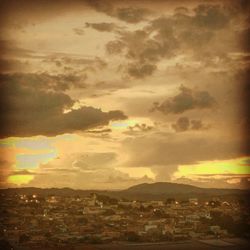 Aerial view of townscape against sky at sunset