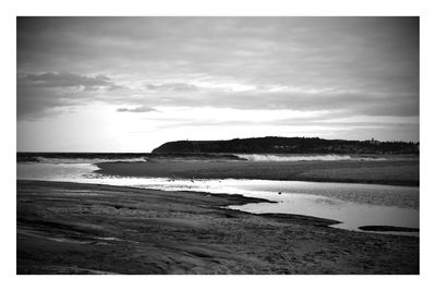 Scenic view of sea against cloudy sky