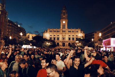 Group of people in front of buildings at night