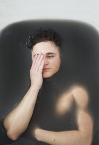 Close-up portrait of young man in water