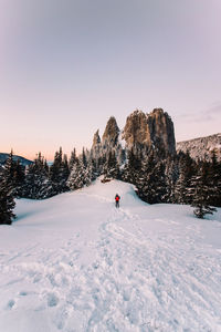 Man on snowcapped mountain against sky