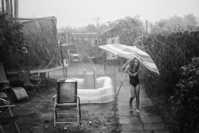 High angle view of holding umbrella standing outdoors