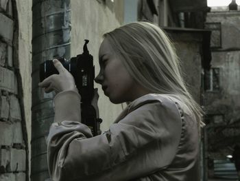 Woman photographing wall with camera