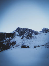 Scenic view of snowcapped mountains against clear blue sky