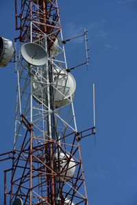 Low angle view of communications tower against sky