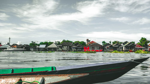 Boats moored on sea against sky