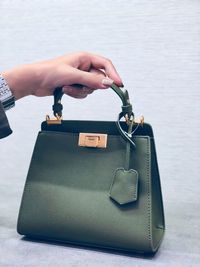 Cropped hand of woman holding purse